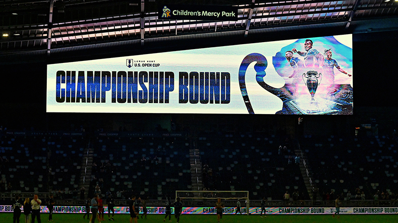 Photo of the Children's Merrcy Park scoreboard displaying "Championship Bound" with a silhouette of the Open Cup trophy